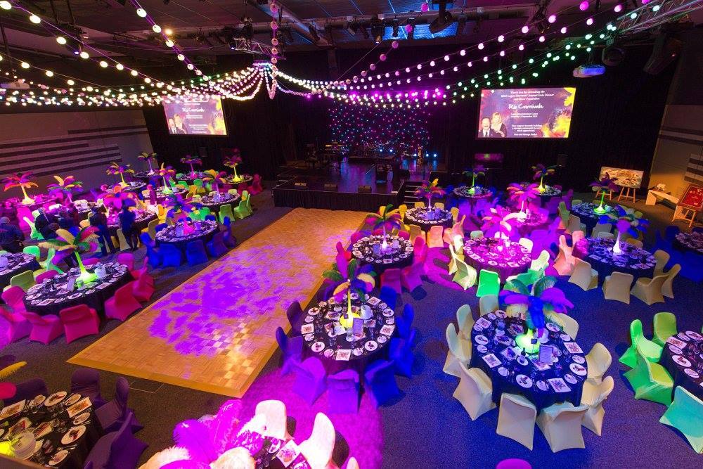 Gala dinner room with festoon canopy and saturated table lighting