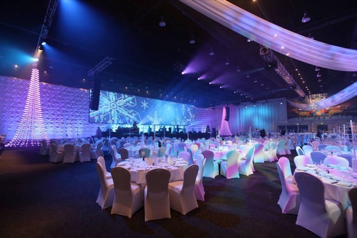 Gala dinner room with draped ceiling and lit tree features